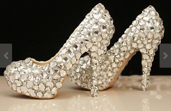 Luxurious White Gold Diamond Engagement Ring Next to Wedding Shoes Bride.  Wedding Details Stock Photo - Alamy